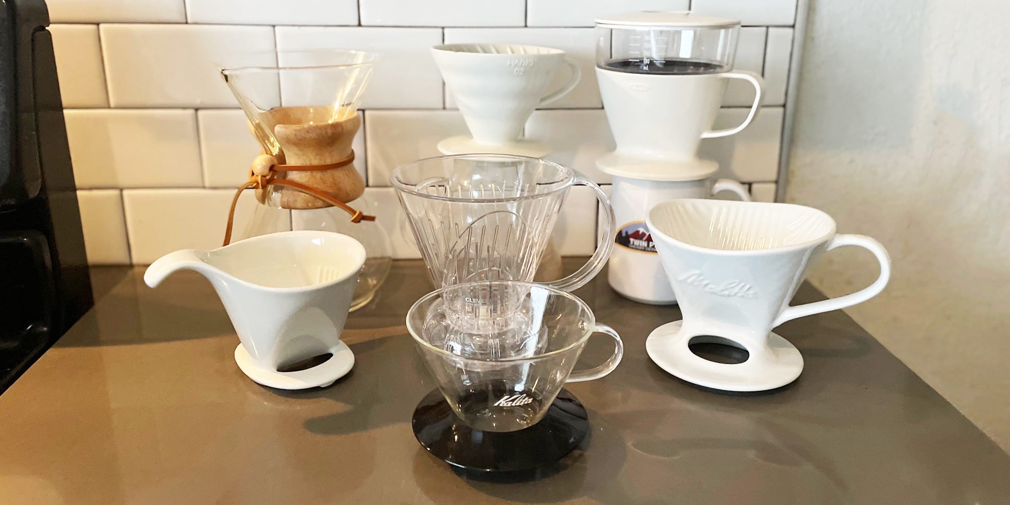 A selection of pour over coffee makers on a kitchen countertop.