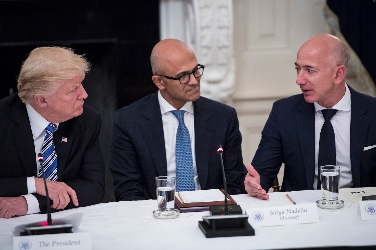 President Donald Trump speaks with Satya Nadella, Chief Executive Officer of Microsoft, and Jeff Bezos, Chief Executive Officer of Amazon during an American Technology Council roundtable in the State Dinning Room at the White House in Washington, DC on Monday, June 19, 2017.