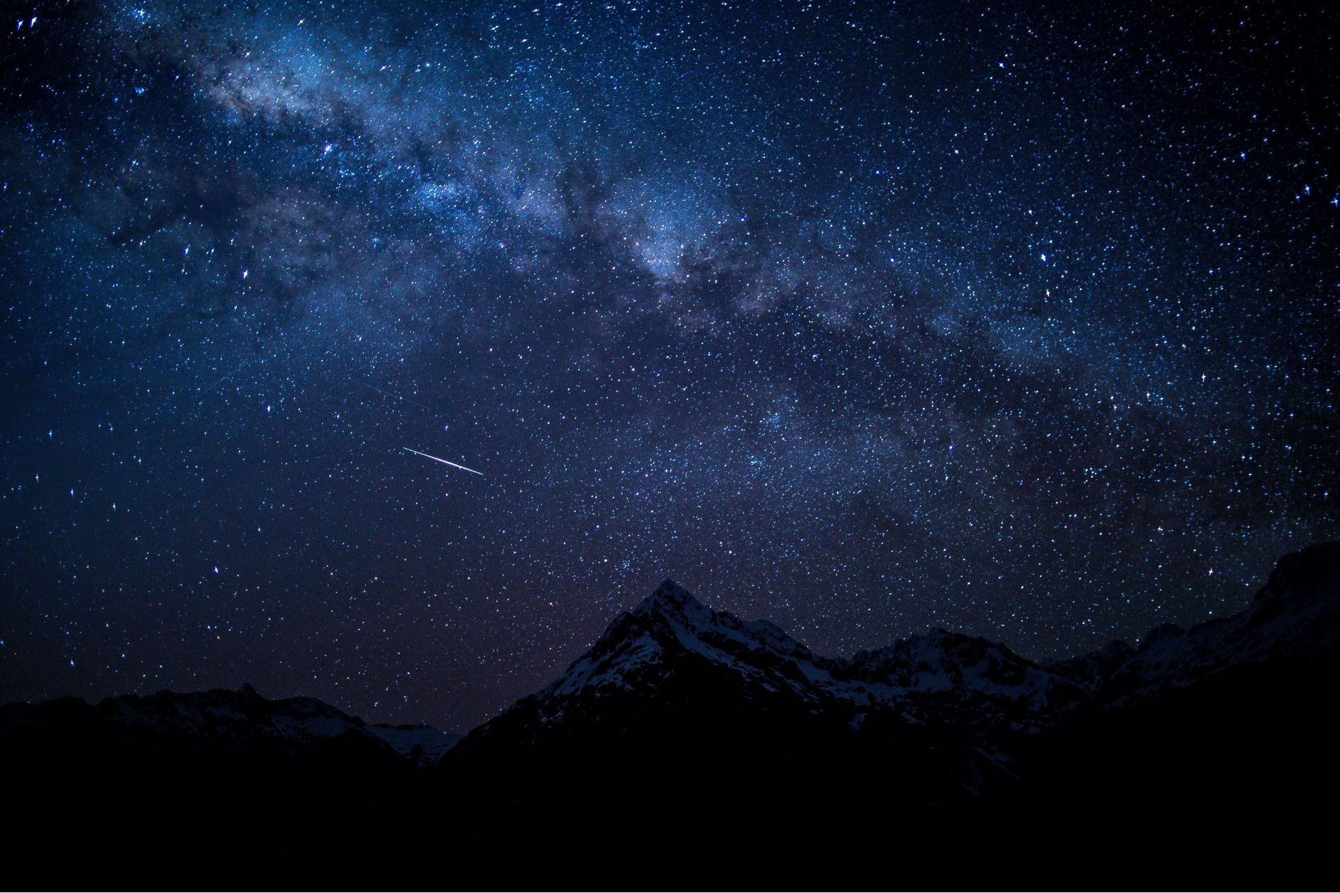 Stars shining over a mountain peak