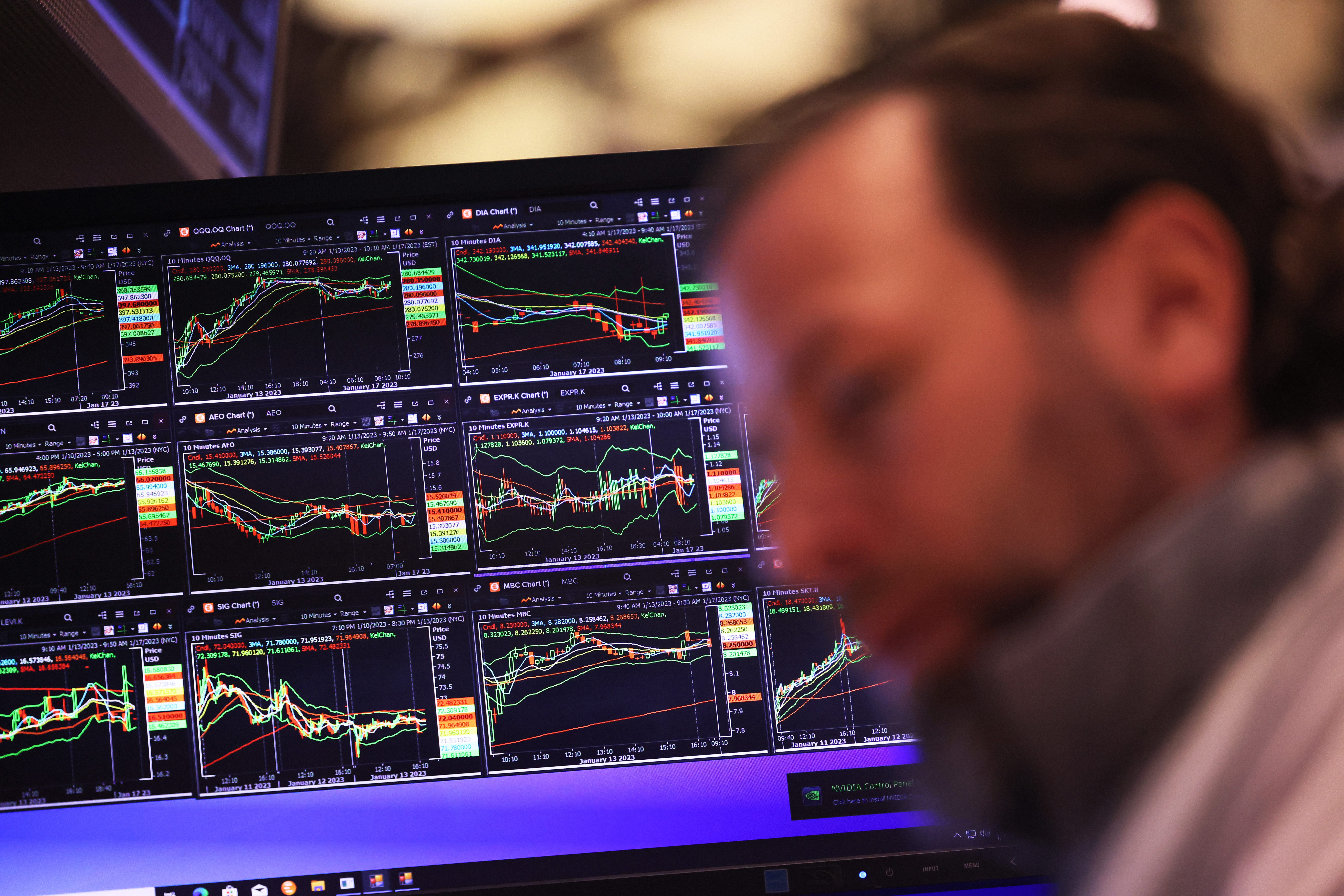 NYSE trader with market screens in the background