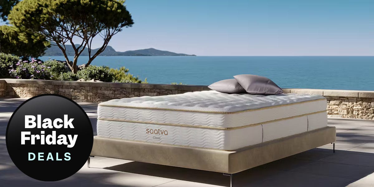 A Saatva Classic Mattress staged outside wiht an ocean in the background. A black badge reads "black friday deals"