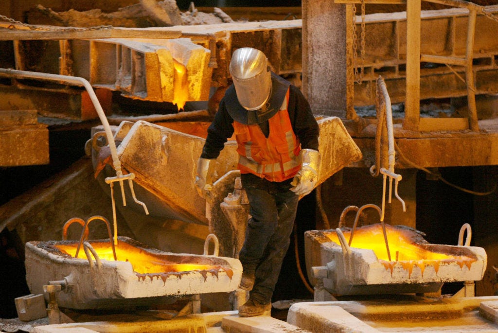 A worker negociates his way amid the melting pots of copper at the foundry of the Chuquicamata copper mine
