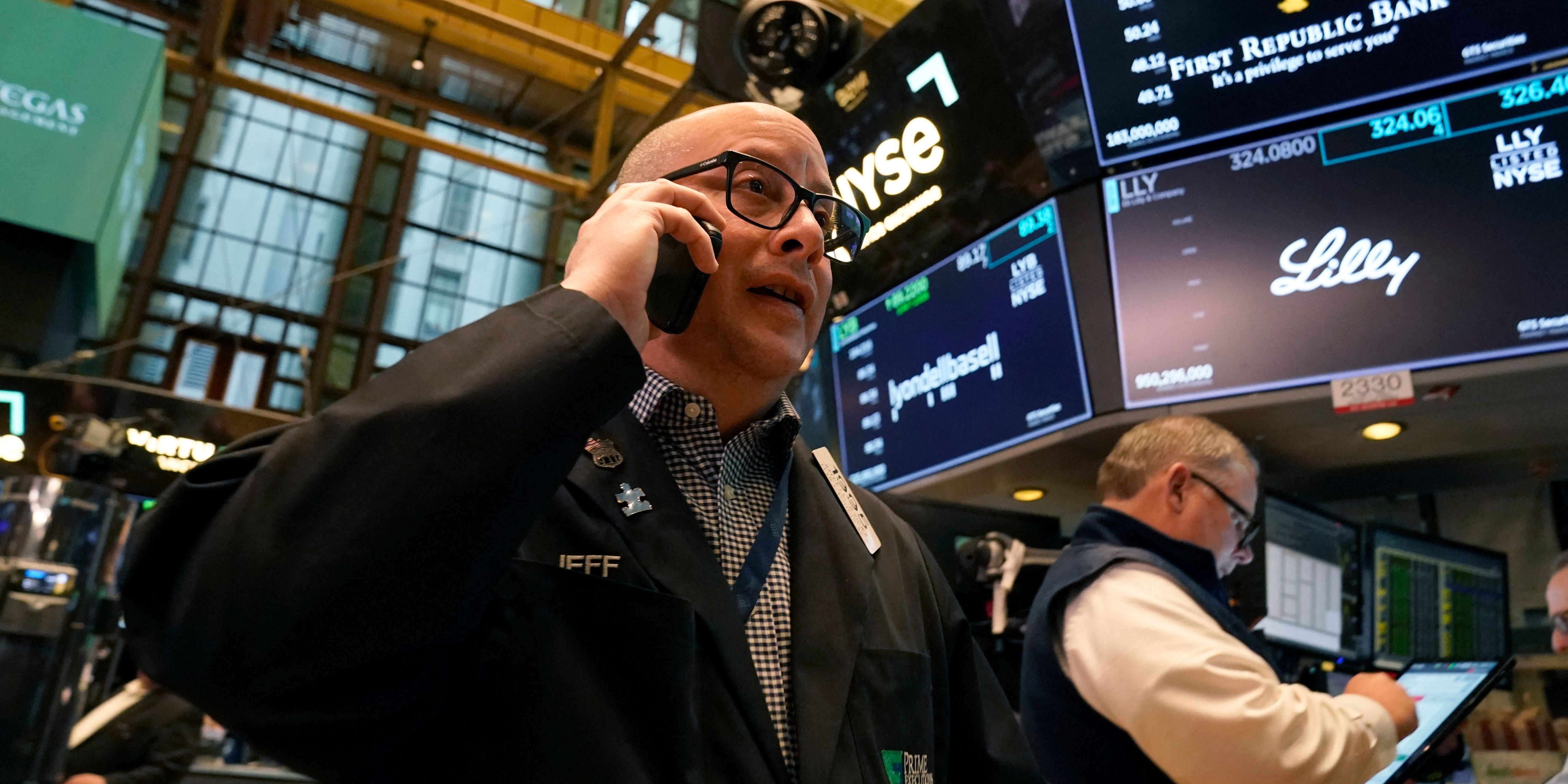 Stock trader at the NYSE speaking on the phone