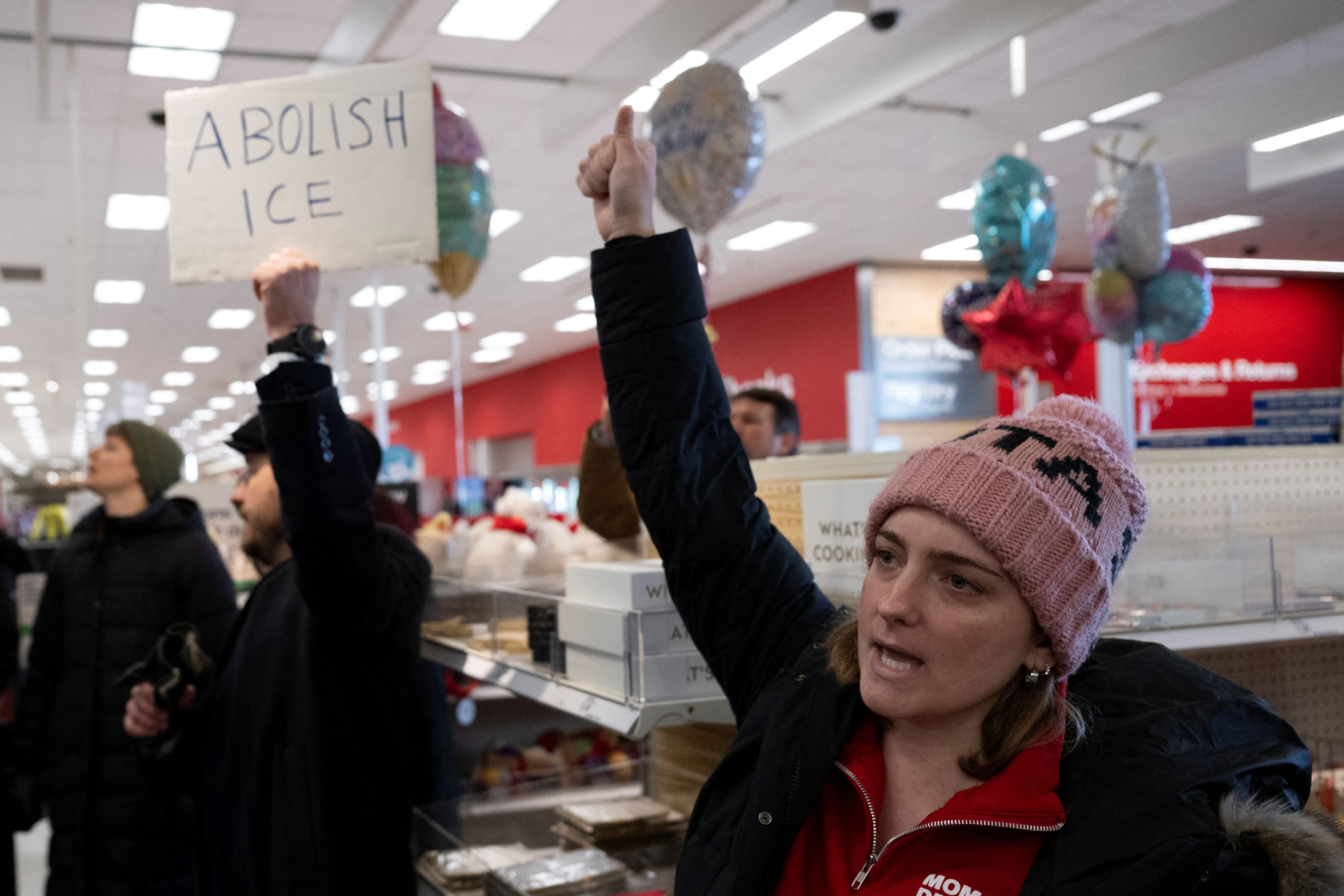 A small crowd of protesters sing along during a sit-in in a Target store as they denounce what they say is complicity by the store to allow Immigration and Customs Enforcement (ICE) agents to come into the store and stage in their parking lot in<br /><a href=