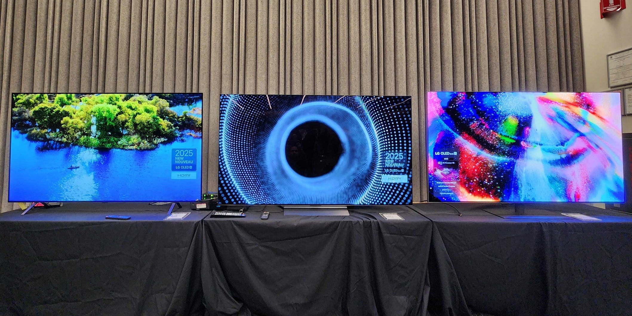 An image of the LG B5, C5, and G5 OLED TVs on display at an LG event.