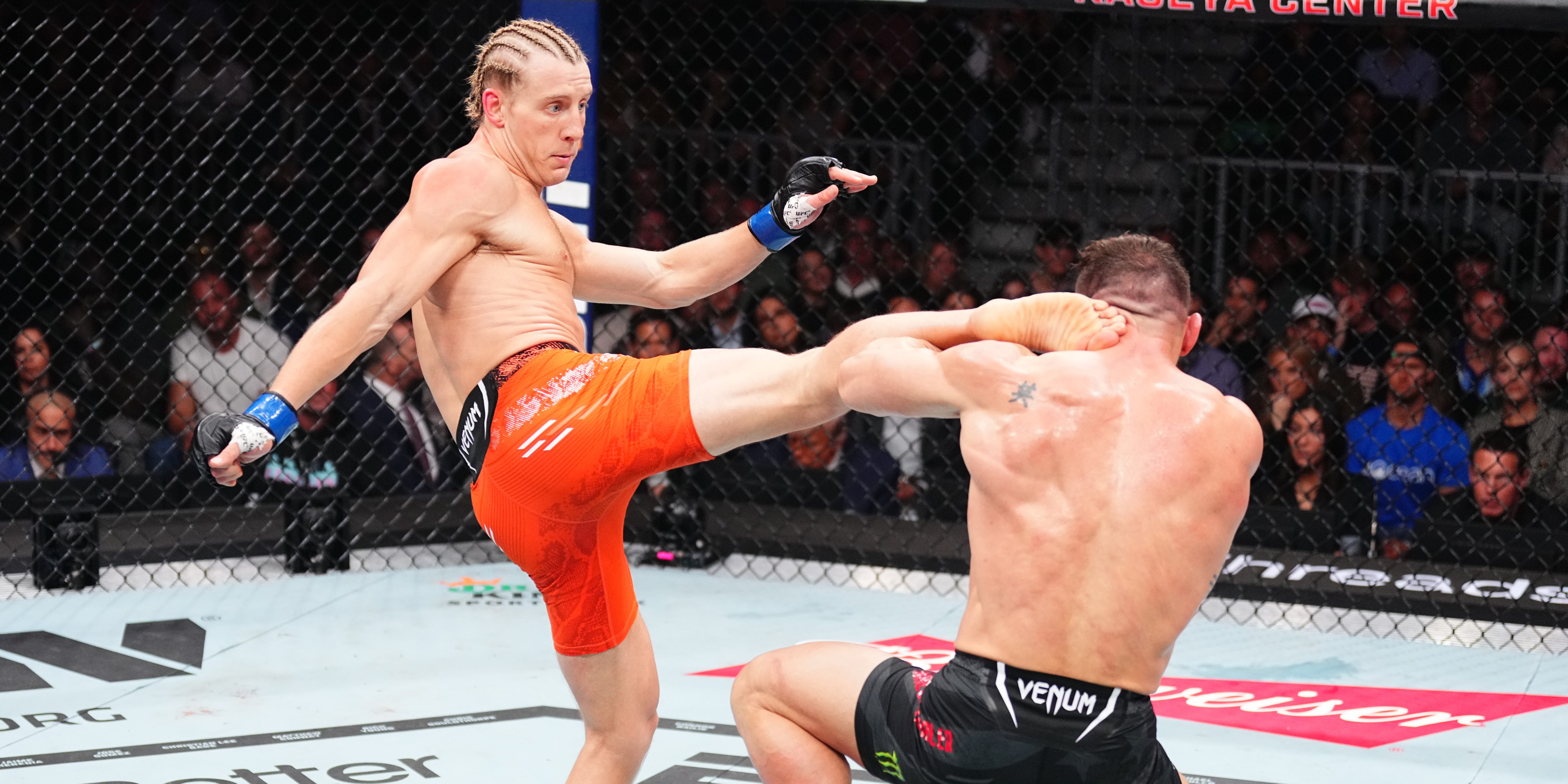 Paddy Pimblett of England kicks Michael Chandler in a lightweight bout during the UFC 314 in 2025.