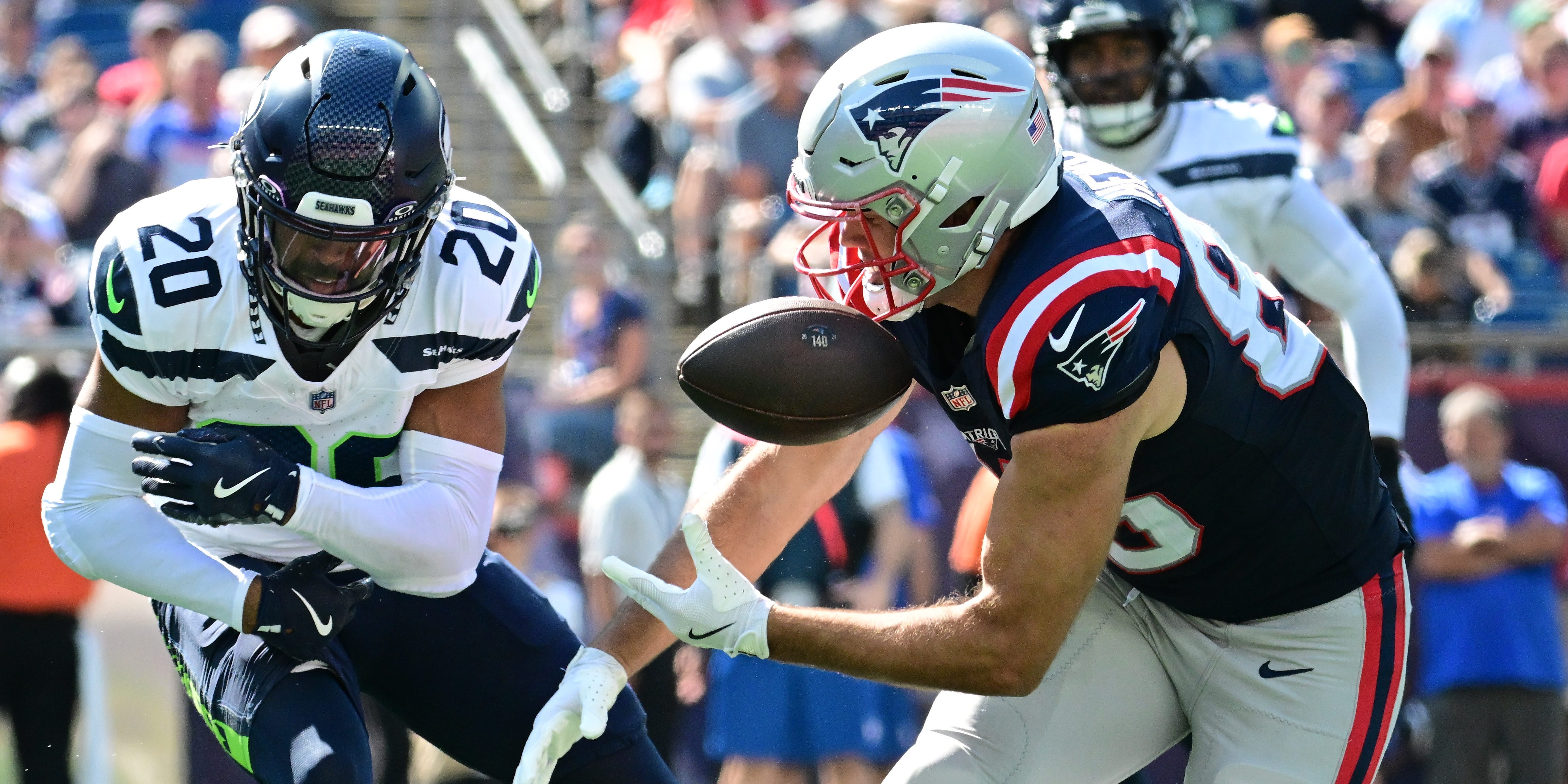 New England Patriots tight end Hunter Henry (85) can't make the catch with Seattle Seahawks safety Julian Love (20) in coverage during a 2024 NFL game.