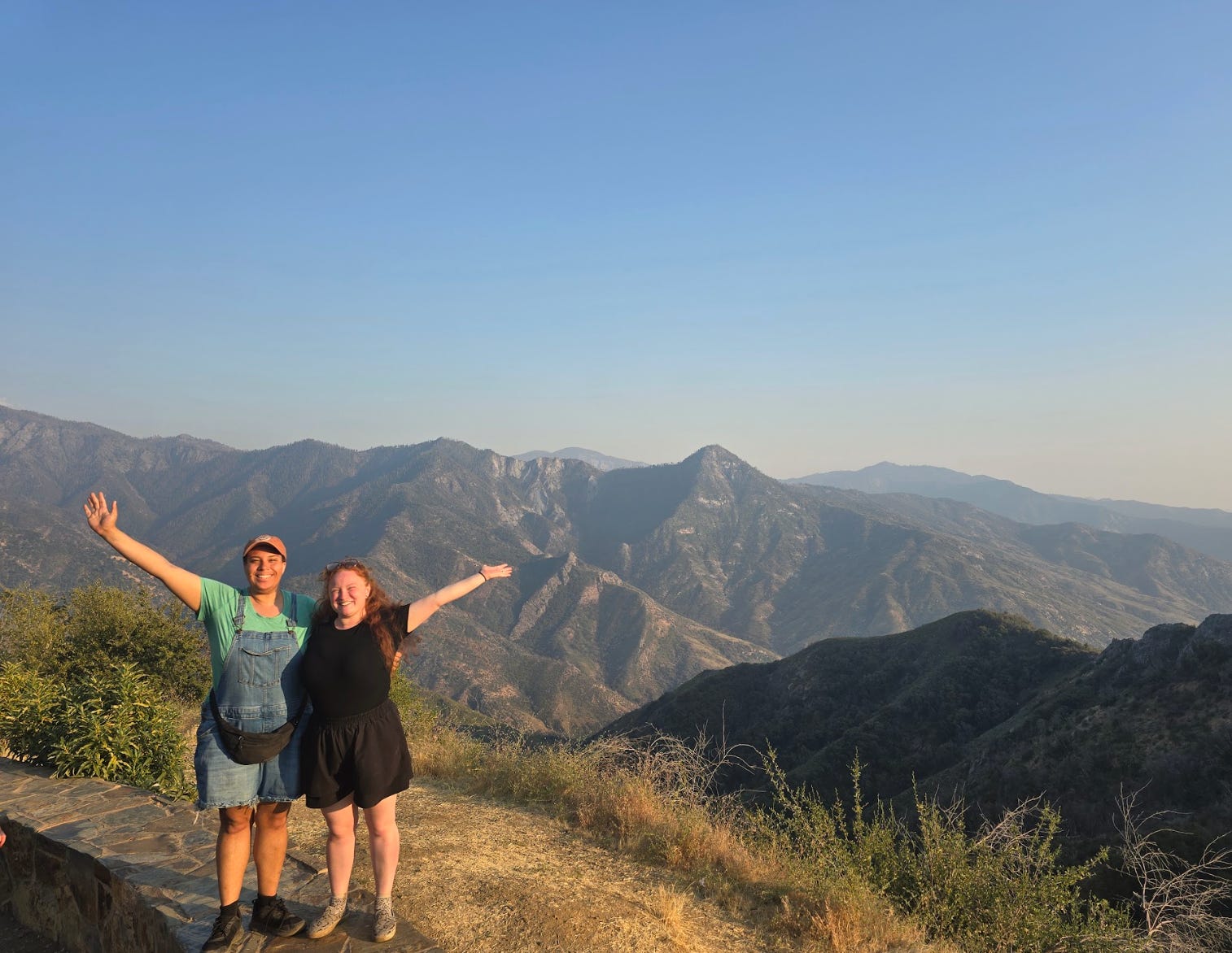 The writer and her friend standing in front of mountains at Sequoia National Park.