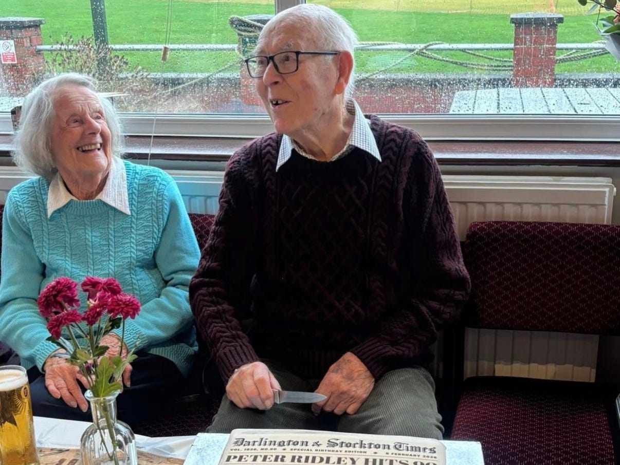 A senior man and woman with a birthday cake