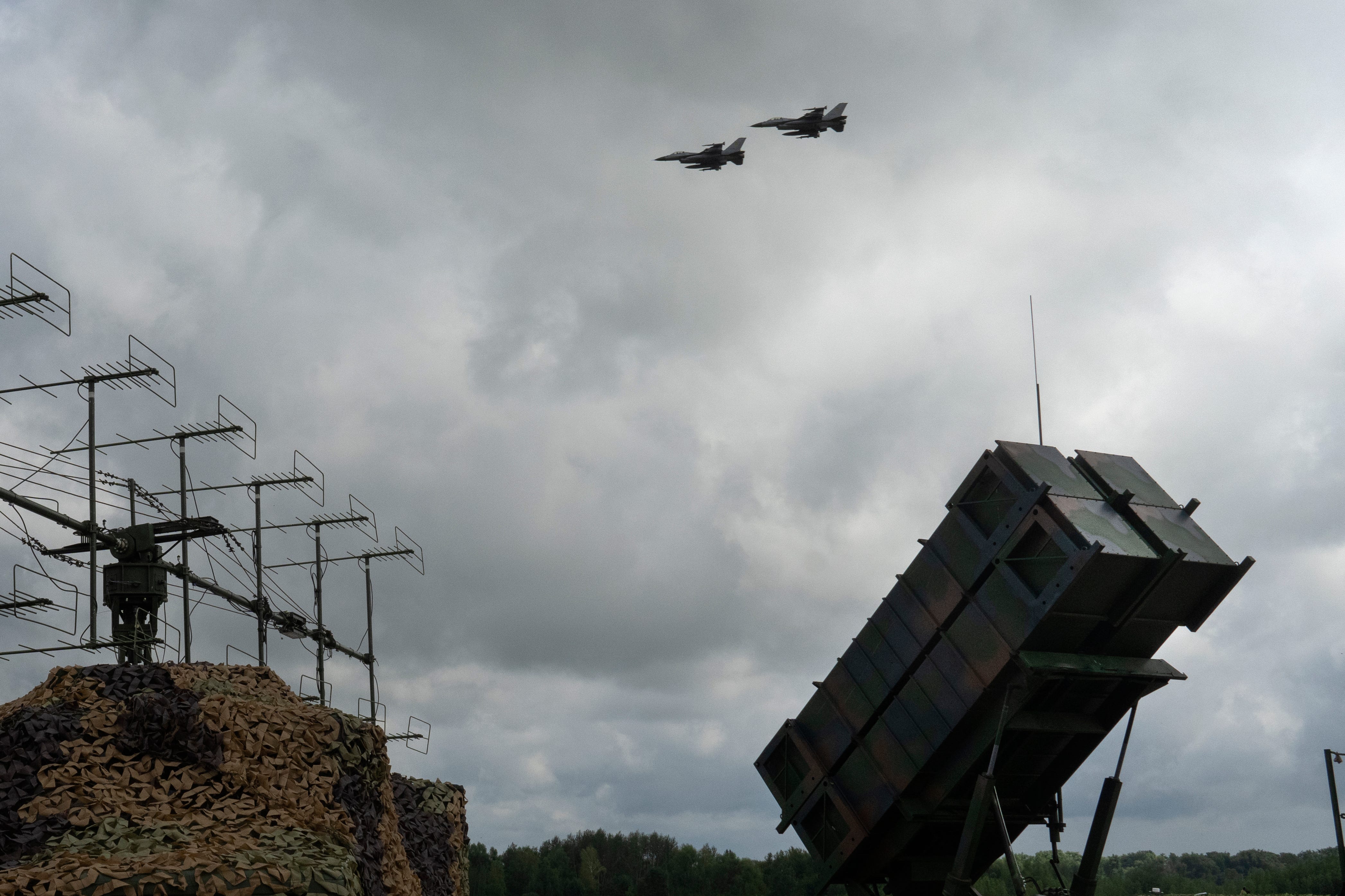 The Ukrainian Air Force's F-16 fighter jets fly over a Patriot Air and Missile Defense System in an undisclosed location in Ukraine, Sunday, August 4, 2024.